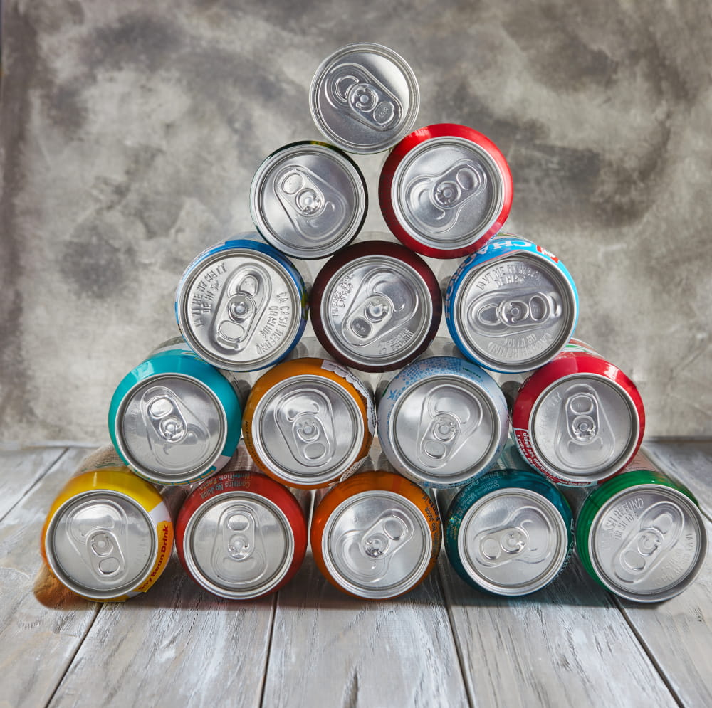 Aluminum cans stacked in a pyramid.